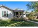 Home with a covered porch, nice landscaping, and a walkway to the backyard at 2862 S Grant St, Englewood, CO 80113