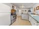 Charming kitchen featuring stainless steel appliances, a center island, and a door to the porch at 2862 S Grant St, Englewood, CO 80113