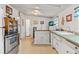 Charming kitchen featuring stainless steel appliances, a center island, and a door to the porch at 2862 S Grant St, Englewood, CO 80113