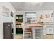 Charming kitchen with a center island, a microwave, a water cooler, and a green bookshelf at 2862 S Grant St, Englewood, CO 80113