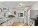 Charming kitchen featuring a door to the porch, stainless steel appliances, and ample countertop space at 2862 S Grant St, Englewood, CO 80113