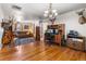 Inviting living room featuring hardwood floors, a comfortable brown couch, rocking chair, and unique decorative wildlife displays at 2862 S Grant St, Englewood, CO 80113