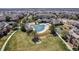 Community aerial view featuring a pool, gazebo, and manicured lawns amid residential buildings at 5705 N Genoa Way # 206, Aurora, CO 80019