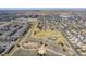 Aerial view of a neighborhood with a large green space featuring walking paths, playgrounds, and community areas at 5705 N Genoa Way # 206, Aurora, CO 80019
