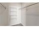 This walk-in closet features white walls, gray carpeting, and four rows of metal shelving at 5705 N Genoa Way # 206, Aurora, CO 80019