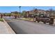First Creek Farm entrance featuring a brick sign and a secure gate along a well-maintained road at 5705 N Genoa Way # 206, Aurora, CO 80019