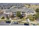Aerial view of a condominium complex boasting well-maintained landscaping and ample parking for residents and guests at 5705 N Genoa Way # 206, Aurora, CO 80019