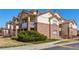 Attractive condominium exterior with brick and siding, featuring private balconies and lush greenery at 5705 N Genoa Way # 206, Aurora, CO 80019