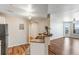 Open concept kitchen with a breakfast bar seamlessly connecting to the living area at 5705 N Genoa Way # 206, Aurora, CO 80019