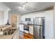 Well-equipped kitchen with stainless steel appliances and access to the laundry area at 5705 N Genoa Way # 206, Aurora, CO 80019
