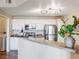 Modern kitchen with white cabinets, stainless steel appliances, and a breakfast bar at 5705 N Genoa Way # 206, Aurora, CO 80019