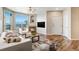 Inviting living room with a fireplace, large windows, and hardwood floors at 5705 N Genoa Way # 206, Aurora, CO 80019