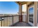 Outdoor patio with a wooden deck, brick accents, and neighborhood view at 5705 N Genoa Way # 206, Aurora, CO 80019