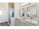 Modern bathroom with double sinks, walk-in shower, and updated fixtures at 16058 E Geddes Ln # 26, Aurora, CO 80016