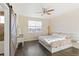 Main bedroom with a king-size bed, wood floors, and barn door at 16058 E Geddes Ln # 26, Aurora, CO 80016