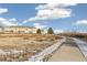 Path and townhomes with a snowy field in the foreground at 16058 E Geddes Ln # 26, Aurora, CO 80016