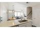 Kitchen with island, stainless steel sink, and view into living room at 16058 E Geddes Ln # 26, Aurora, CO 80016