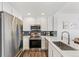 Modern kitchen with stainless steel appliances and white cabinets at 16058 E Geddes Ln # 26, Aurora, CO 80016