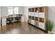 Bright home office featuring a built-in shelving unit and two workstations at 16058 E Geddes Ln # 26, Aurora, CO 80016