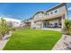 The backyard features a lush lawn, privacy fence, and a covered patio for outdoor enjoyment at 3008 Blithe Pt, Castle Rock, CO 80108