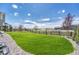 The backyard features a well-manicured lawn, enhanced by decorative rock and a rustic wooden fence at 3008 Blithe Pt, Castle Rock, CO 80108