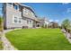Large, green lawn in backyard featuring partial fence and access to covered patio at 3008 Blithe Pt, Castle Rock, CO 80108