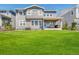The backyard includes a well-maintained lawn, fence, and an inviting patio with outdoor seating at 3008 Blithe Pt, Castle Rock, CO 80108