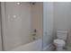 Clean bathroom featuring a shower-tub combo and toilet, with neutral color palette at 3008 Blithe Pt, Castle Rock, CO 80108