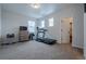 Versatile bonus room with treadmill, storage, and natural light, perfect for fitness or hobbies at 3008 Blithe Pt, Castle Rock, CO 80108