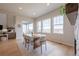 Light-filled dining area features wood floors, large windows, and a modern table setting at 3008 Blithe Pt, Castle Rock, CO 80108