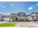 Charming two-story home featuring a well-manicured lawn and a spacious two-car garage at 3008 Blithe Pt, Castle Rock, CO 80108