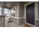 Inviting front porch featuring stone accents, a cozy seating area, and a stylish front door at 3008 Blithe Pt, Castle Rock, CO 80108