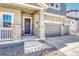 Close-up of a home showcasing the front entrance, a two-car garage and stone brick accents at 3008 Blithe Pt, Castle Rock, CO 80108