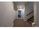 Hallway with neutral carpet and walls leads to the basement; access to carpeted stairs at 3008 Blithe Pt, Castle Rock, CO 80108