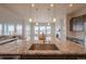 Kitchen with granite island featuring sink, modern fixtures, and open view to living and dining areas at 3008 Blithe Pt, Castle Rock, CO 80108