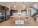 Stylish kitchen island with seating, pendant lights, stainless appliances, and sleek dark cabinets at 3008 Blithe Pt, Castle Rock, CO 80108