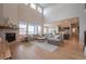Spacious living room with fireplace, ample natural light, and an open floor plan at 3008 Blithe Pt, Castle Rock, CO 80108