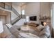 Expansive living room with high ceilings, fireplace, and a comfortable sectional, perfect for entertaining at 3008 Blithe Pt, Castle Rock, CO 80108