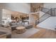 Bright open concept living room features high ceilings, stairs, and seamless connection to kitchen at 3008 Blithe Pt, Castle Rock, CO 80108