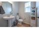 Well-lit powder room featuring a pedestal sink, modern fixtures, and stylish decor at 3008 Blithe Pt, Castle Rock, CO 80108