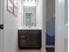 Stylish powder room with modern vanity, decorative mirror, and mountain themed wall art at 3008 Blithe Pt, Castle Rock, CO 80108