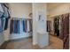 Spacious walk-in closet featuring ample hanging space and built-in shelving for organized storage at 3008 Blithe Pt, Castle Rock, CO 80108