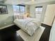 Cozy bedroom with a queen-size bed and dark hardwood floors at 2394 S Loveland Way, Lakewood, CO 80228