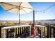 Deck with mountain views, table, chairs, and umbrella at 2394 S Loveland Way, Lakewood, CO 80228