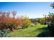 Landscaped yard with trees and mountain views at 2394 S Loveland Way, Lakewood, CO 80228