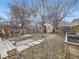 Landscaped backyard featuring a wooden deck, stone pathway, and a well-maintained lawn at 1475 Saint Paul St, Denver, CO 80206