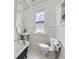 Clean bathroom featuring a classic clawfoot tub, pedestal sink, and natural light, offering a timeless design at 1475 Saint Paul St, Denver, CO 80206