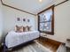 Cozy bedroom with daybed, bright window, hardwood floor, and unique wood trim at 1475 Saint Paul St, Denver, CO 80206