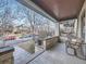 Covered front porch with a swing and brick details overlooking the quiet neighborhood street at 1475 Saint Paul St, Denver, CO 80206