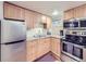 Galley kitchen with stainless appliances, ample wood cabinets, and lots of natural light at 1475 Saint Paul St, Denver, CO 80206